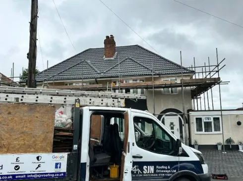 SJN Roofing van on site with new tiled roof