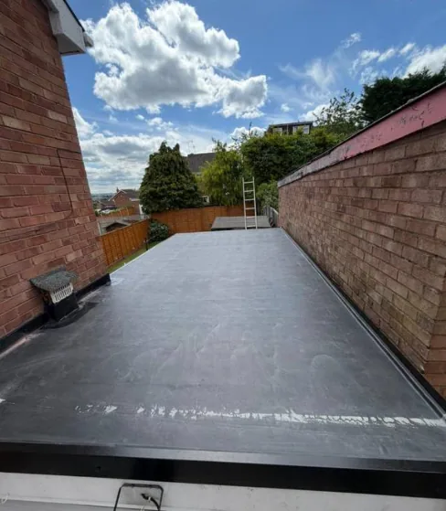Flat rubber roof with clear blue sky